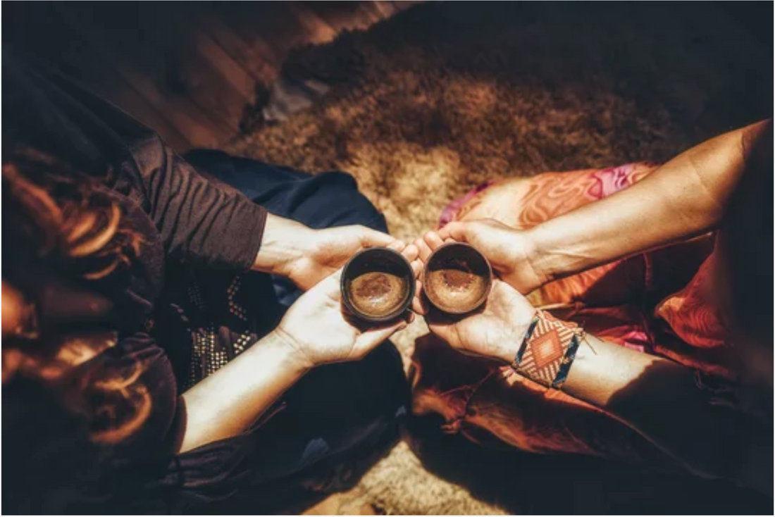 Hands holding a cup of ceremonial cacao as part of a ritual practice